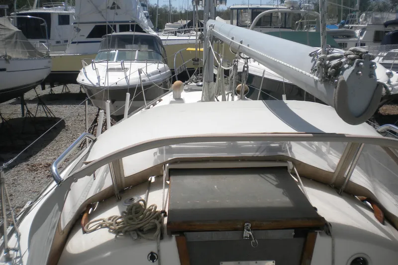 Slide: The Image of 1980 Sabre 34 sailboat on land, surrounded by other boats in a marina. - 66