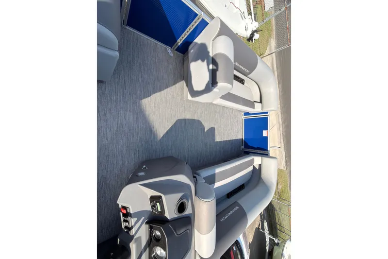 Slide: The Image of 2024 Bennington SVL boat cockpit with steering wheel and dashboard controls. - 12