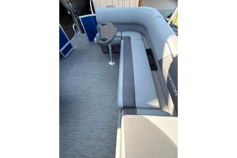 Slide: The Image of 2024 Bennington SVL boat interior with gray seating and a small table. - 5