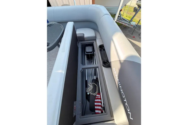 Slide: The Image of 2024 Bennington SVL boat interior with open storage compartment and visible accessories. - 6
