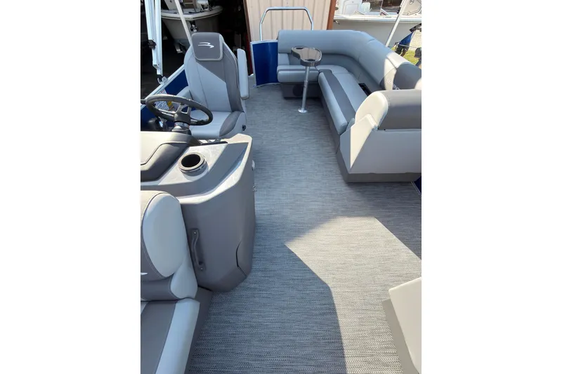 Slide: The Image of 2024 Bennington SVL boat interior with gray seating and steering console. - 7