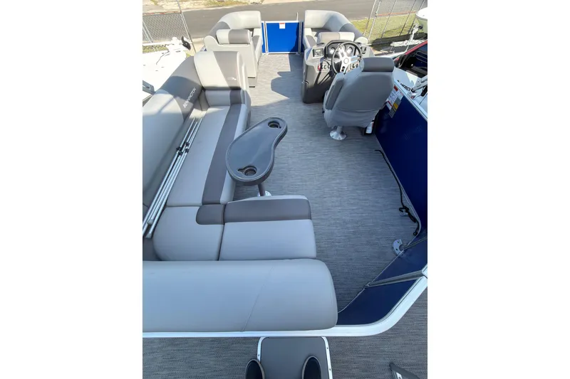 Slide: The Image of 2024 Bennington SVL boat interior with gray seating and steering console. - 8