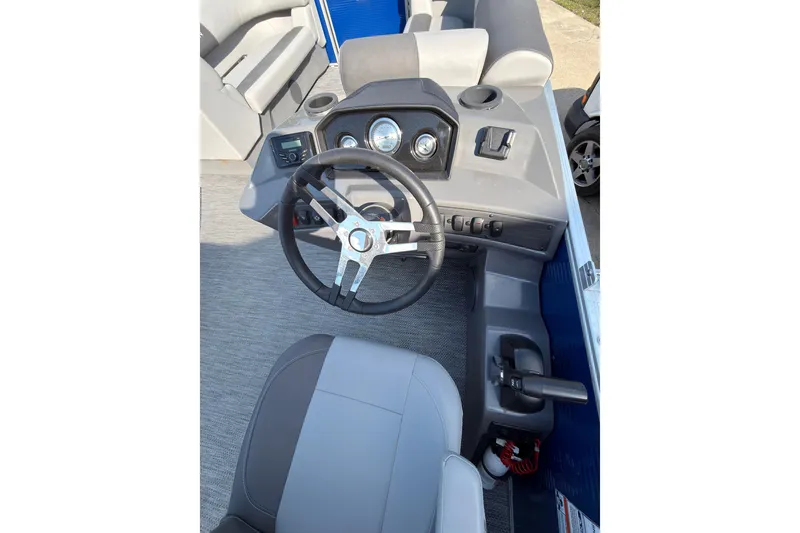 Slide: The Image of 2024 Bennington SVL boat cockpit with steering wheel and dashboard controls. - 9