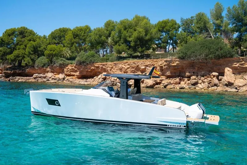 Slide: The Image of Tesoro 40 yacht 2026 in clear waters near rocky coastline. - 6