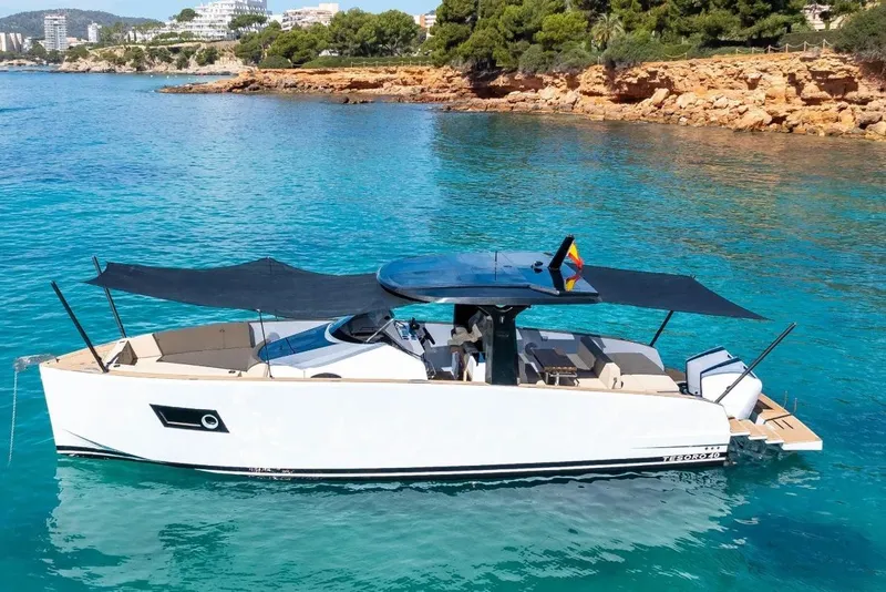 Slide: The Image of Tesoro 40 Yacht 2026 on clear water near rocky coastline. - 4