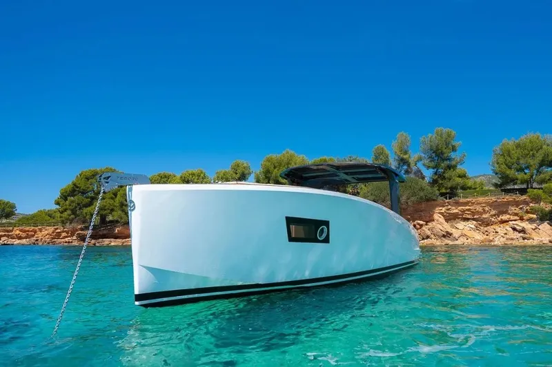 Slide: The Image of Tesoro 40 Yacht 2026 in clear water near a rocky coastline. - 7