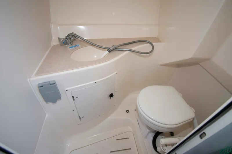 Slide: The Image of Compact bathroom in 2000 Pursuit 2860 Denali boat with toilet and sink. - 15