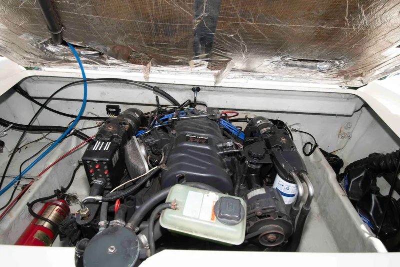 Slide: The Image of Engine compartment of a 2000 Pursuit 2860 Denali boat, showcasing mechanical components. - 16