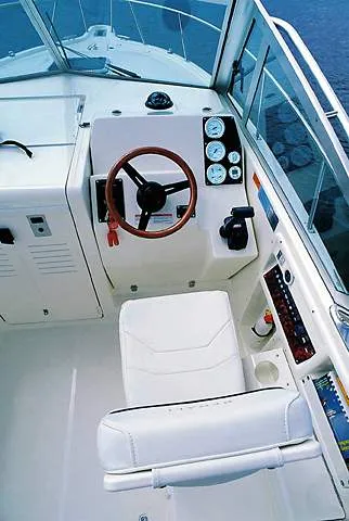 Slide: The Image of 2000 Pursuit 2860 Denali boat docked at marina with clear sky. - 2