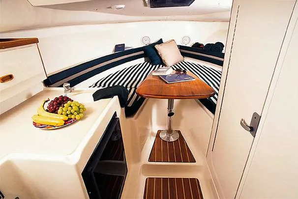 Slide: The Image of 2000 Pursuit 2860 Denali boat interior with white seating and steering console. - 4