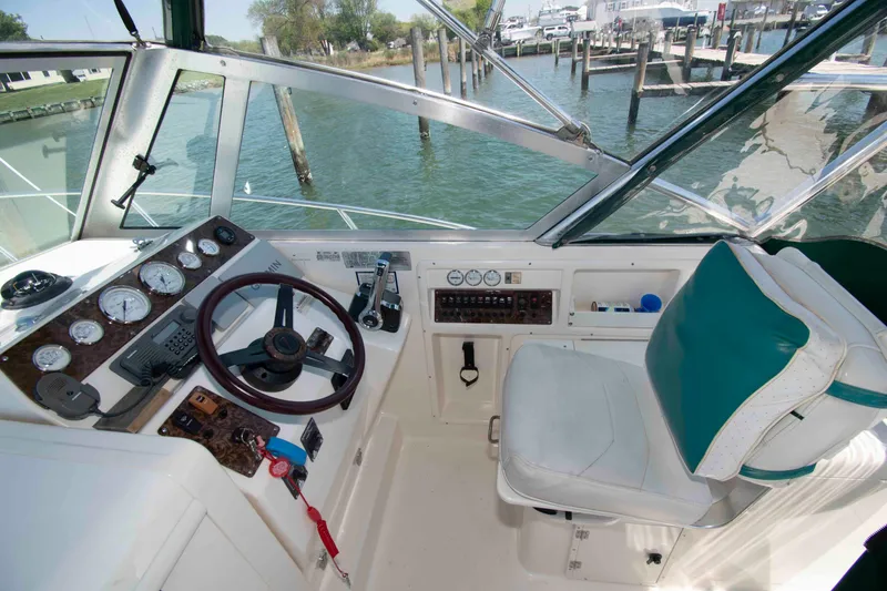 Slide: The Image of Helm of 2000 Pursuit 2860 Denali boat with steering wheel and gauges. - 5
