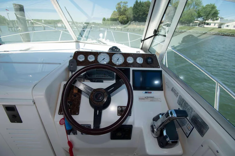 Slide: The Image of Helm of 2000 Pursuit 2860 Denali boat with steering wheel and control panel. - 6