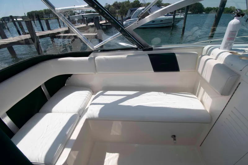 Slide: The Image of Interior seating of 2000 Pursuit 2860 Denali boat, docked by the water. - 7