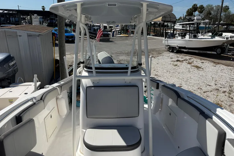Slide: The Image of 2022 Aquasport 2300 Center Console boat interior at a marina. - 10