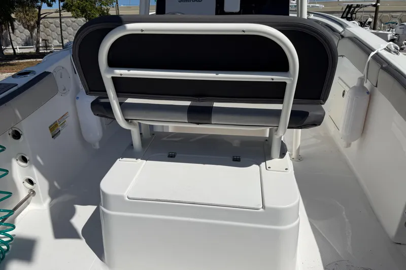 Slide: The Image of 2022 Aquasport 2300 Center Console boat interior with seating and storage. - 12