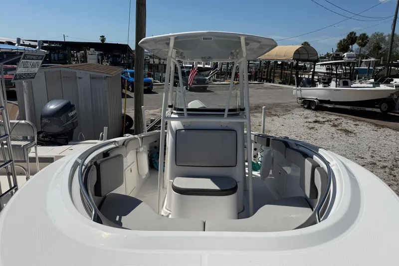 Slide: The Image of 2022 Aquasport 2300 Center Console boat at marina, featuring spacious seating and modern design. - 4
