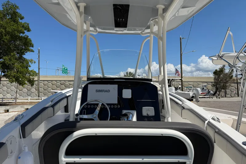 Slide: The Image of 2022 Aquasport 2300 Center Console boat interior with Simrad navigation system. - 6