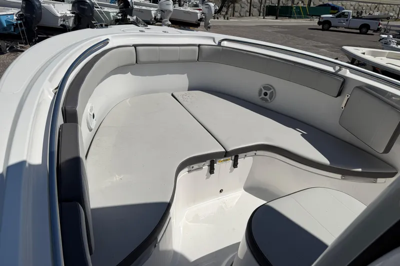Slide: The Image of 2022 Aquasport 2300 Center Console boat interior with cushioned seating and speaker. - 9