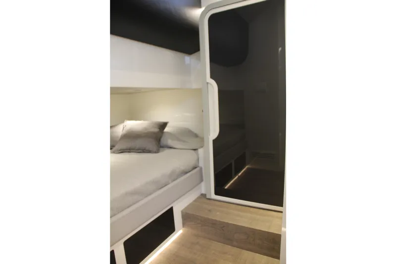 Slide: The Image of 2023 Canados 493 Gladiator interior cabin with modern bedding and ambient lighting. - 19