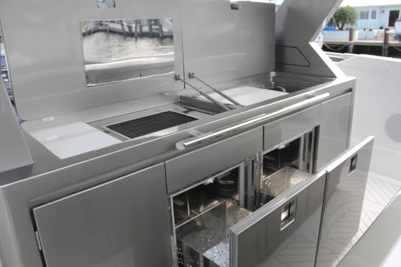 Slide: The Image of Outdoor kitchen on 2023 Canados 493 Gladiator yacht with grill and storage compartments. - 8