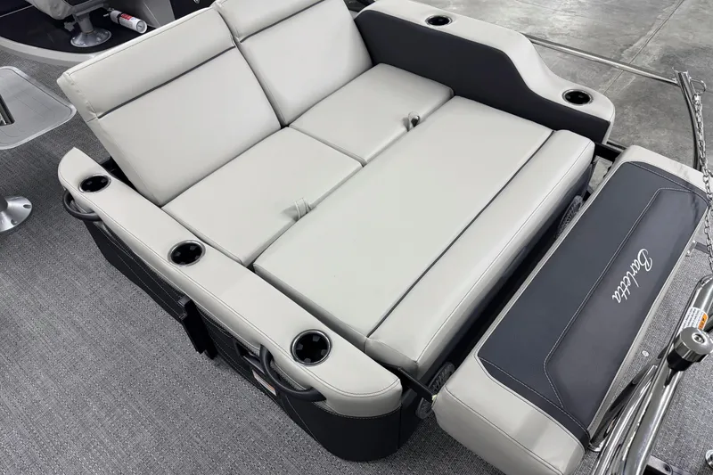 Slide: The Image of 2026 Barletta Cabrio 24UE boat interior with luxurious seating and cup holders. - 11