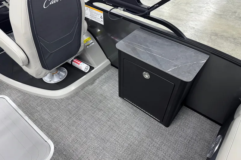 Slide: The Image of Interior of 2026 Barletta Cabrio 24UE boat with seating and storage cabinet. - 15