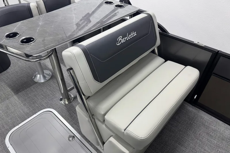 Slide: The Image of 2026 Barletta Cabrio 24UE boat interior with elegant seating and table design. - 21