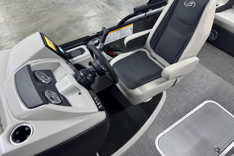 Slide: The Image of 2026 Barletta Cabrio 24UE boat interior with steering wheel and captain's chair. - 22