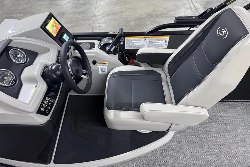 Slide: The Image of 2026 Barletta Cabrio 24UE boat helm with modern controls and comfortable captain's chair. - 23