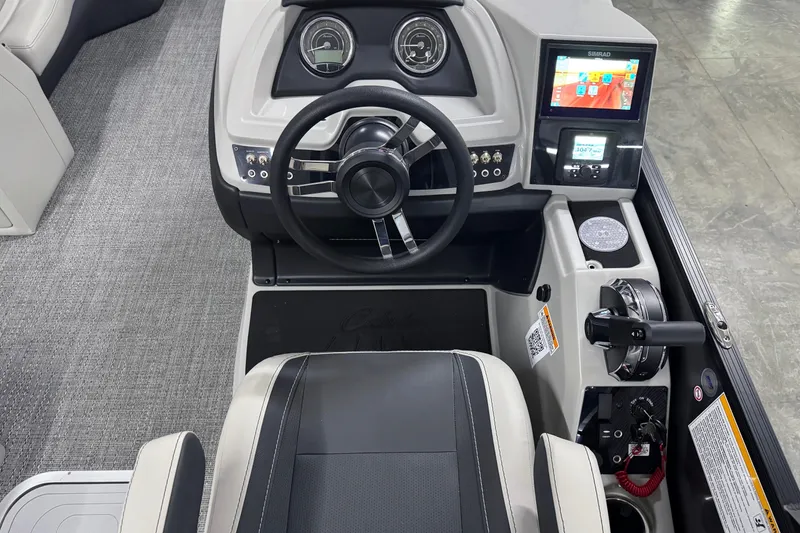 Slide: The Image of 2026 Barletta Cabrio 24UE boat dashboard with steering wheel and digital display. - 25