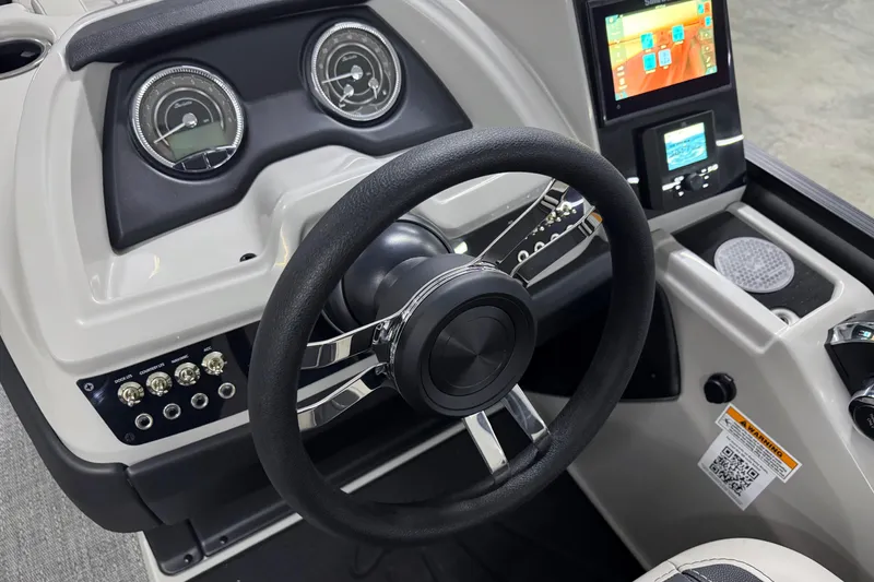 Slide: The Image of 2026 Barletta Cabrio 24UE boat dashboard with steering wheel and digital display. - 26