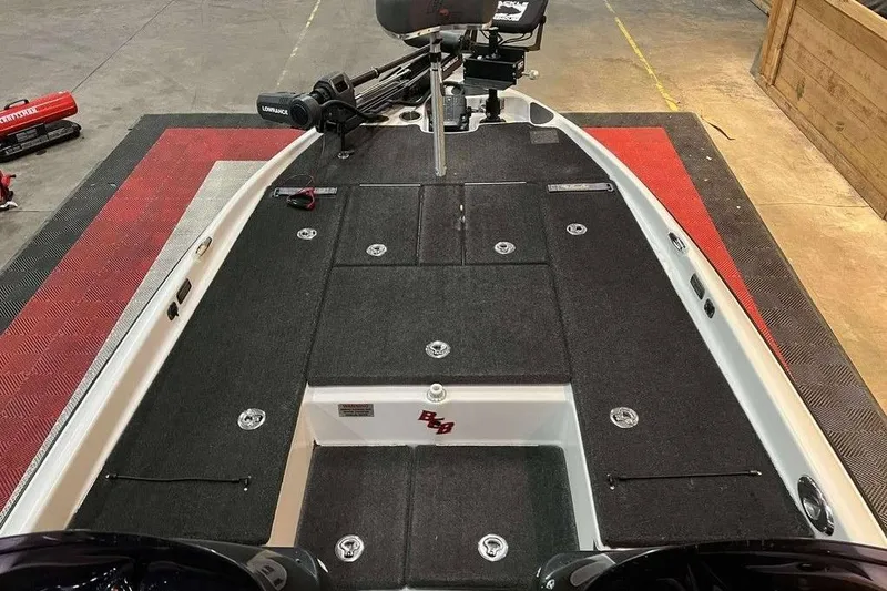 Slide: The Image of 2010 Bass Cat Puma boat deck with storage compartments and fishing seat. - 16