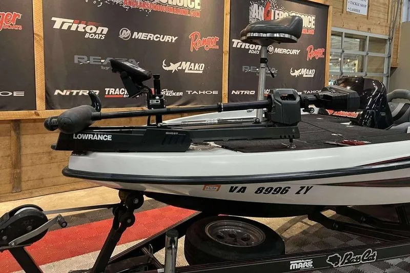 Slide: The Image of 2010 Bass Cat Puma boat with Lowrance equipment on display indoors. - 17