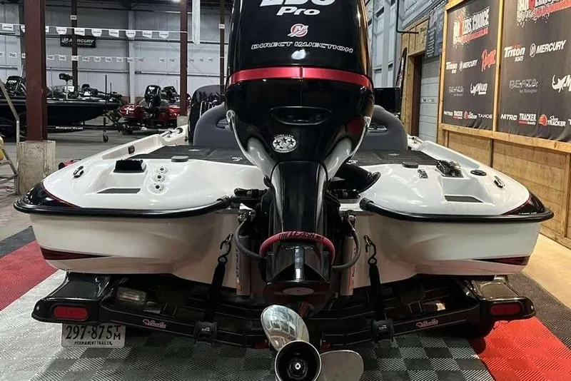 Slide: The Image of 2010 Bass Cat Puma boat with powerful engine in showroom setting. - 3