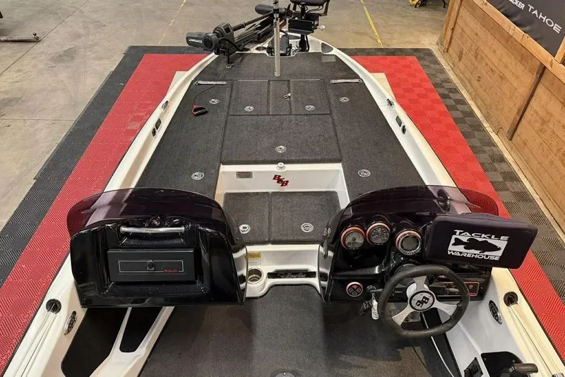 Slide: The Image of 2010 Bass Cat Puma boat interior with steering wheel, gauges, and tackle storage. - 6