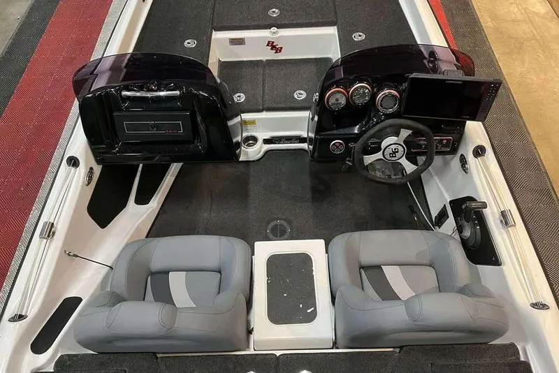 Slide: The Image of 2010 Bass Cat Puma boat interior with dual seats, steering console, and dashboard controls. - 7