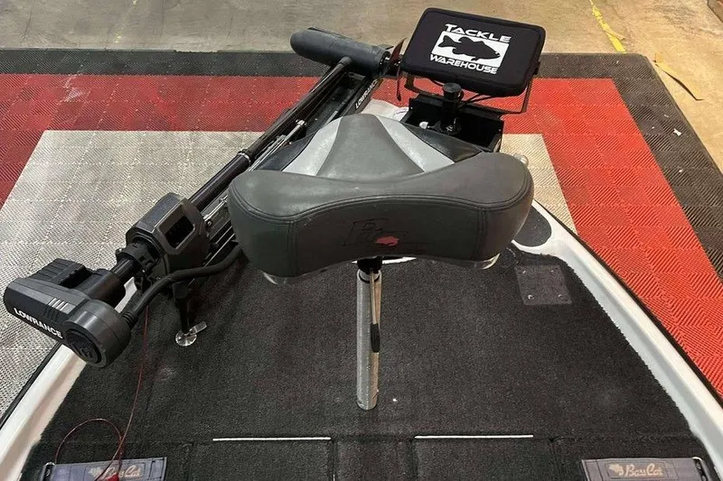 Slide: The Image of 2010 Bass Cat Puma boat deck with Lowrance equipment and Tackle Warehouse branding. - 8