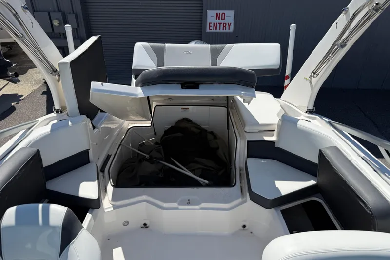 Slide: The Image of 2019 Regal 21 OBX boat interior with open storage compartment, seating, and "No Entry" sign. - 11