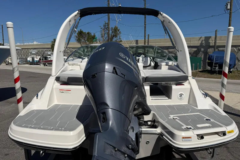 Slide: The Image of 2019 Regal 21 OBX boat with Yamaha outboard motor, docked in a marina. - 3