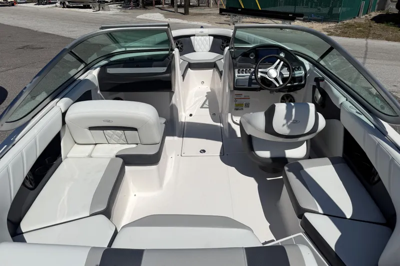 Slide: The Image of 2019 Regal 21 OBX boat interior with white seating and modern dashboard. - 5