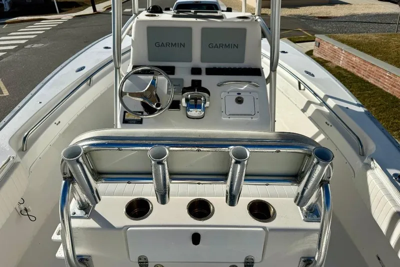 Slide: The Image of 2007 Cape Horn 24 OS boat cockpit with Garmin navigation system and rod holders. - 2