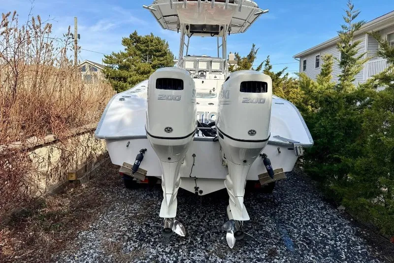 Slide: The Image of 2007 Cape Horn 24 OS boat with dual outboard engines, parked outdoors. - 5