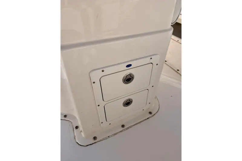 Slide: The Image of 2007 Cape Horn 24 OS boat storage compartments with secure locks. - 8