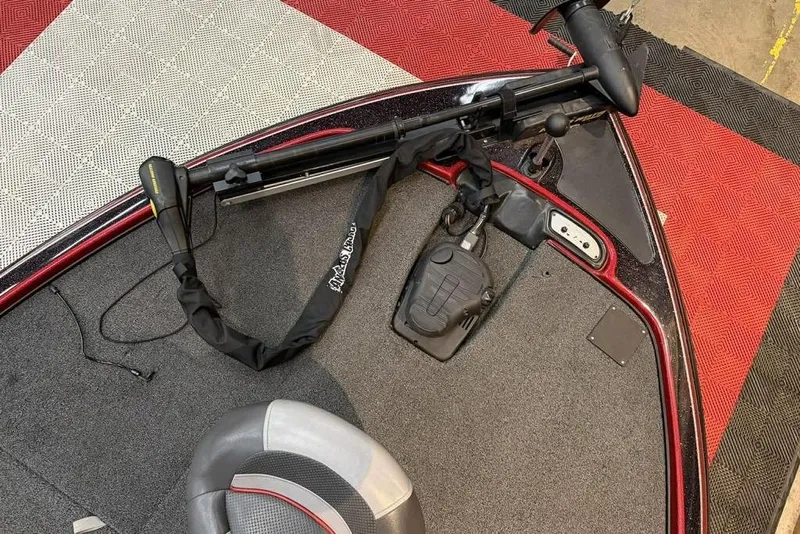 Slide: The Image of 2013 Nitro Z-6 boat deck with trolling motor and seat, on red and gray flooring. - 7