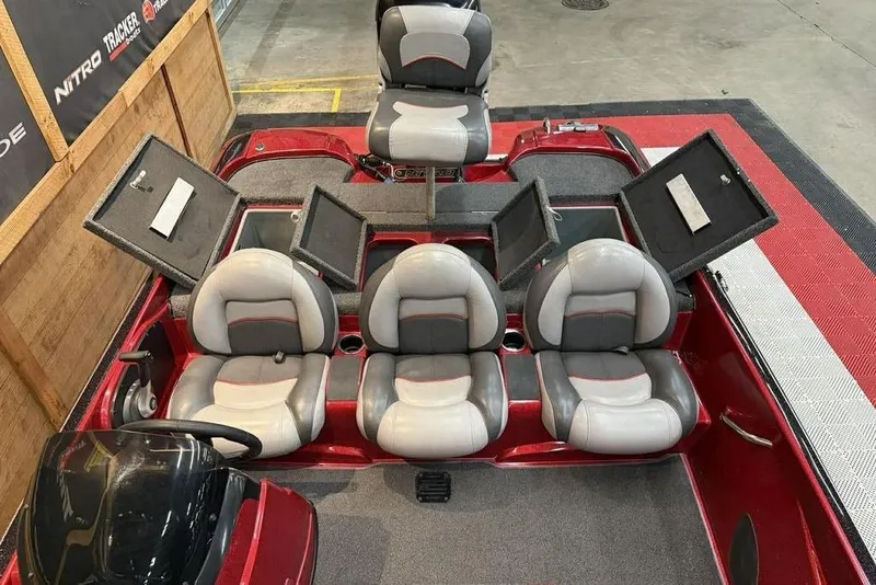 Slide: The Image of 2013 Nitro Z-6 boat interior with gray seats and open storage compartments. - 9