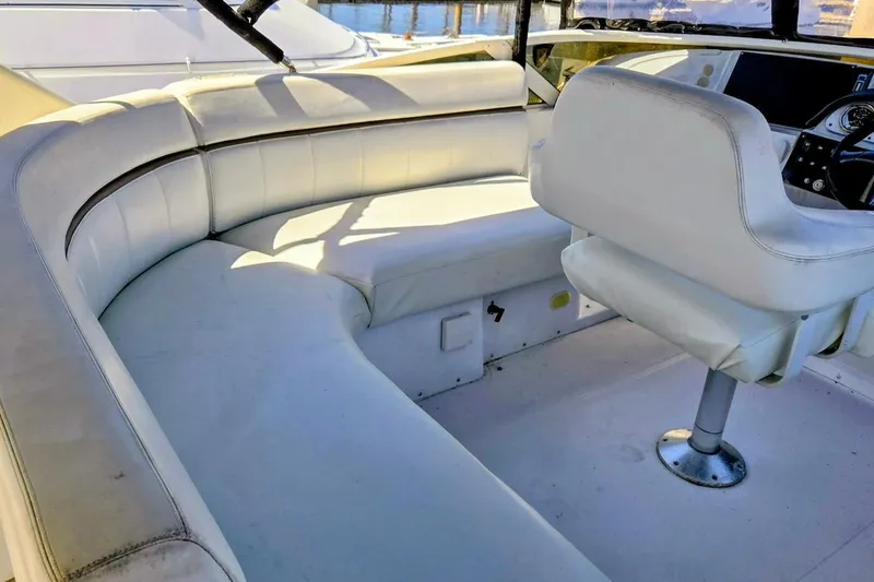 Slide: The Image of 2000 Carver 396 Motor Yacht interior with white seating and helm station. - 10