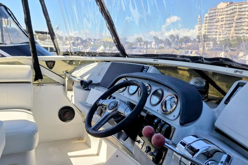 Slide: The Image of Interior view of 2000 Carver 396 Motor Yacht helm with steering wheel and controls. - 14