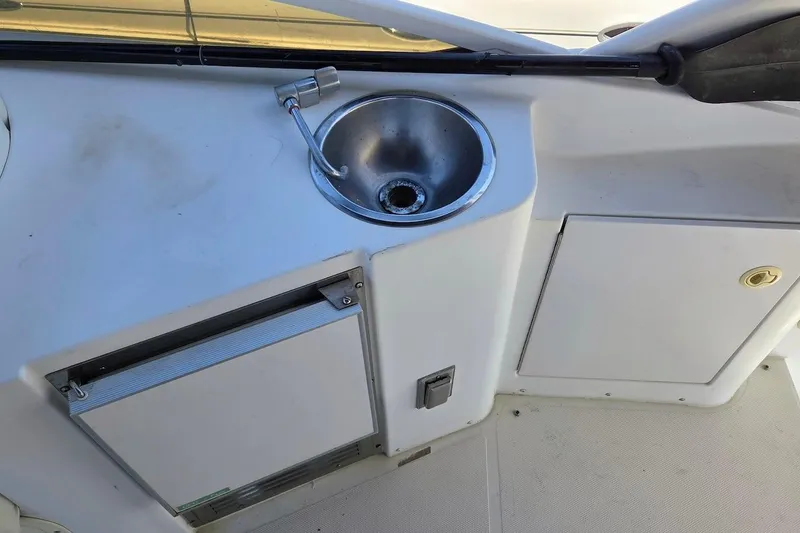 Slide: The Image of 2000 Carver 396 Motor Yacht sink and storage area on deck. - 17