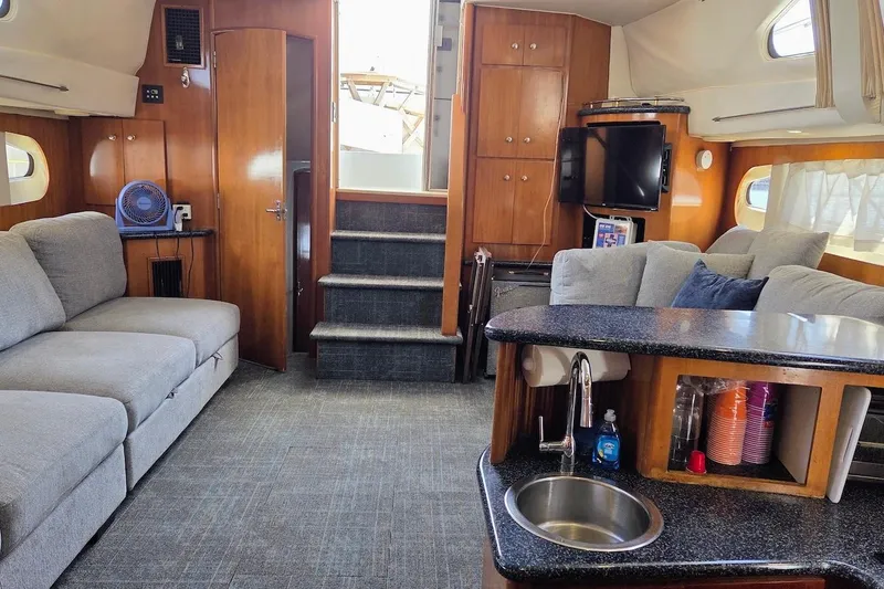 Slide: The Image of Interior of 2000 Carver 396 Motor Yacht with modern furnishings and kitchenette. - 21