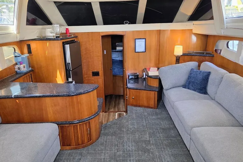 Slide: The Image of Interior of 2000 Carver 396 Motor Yacht with modern furnishings and cozy seating area. - 23
